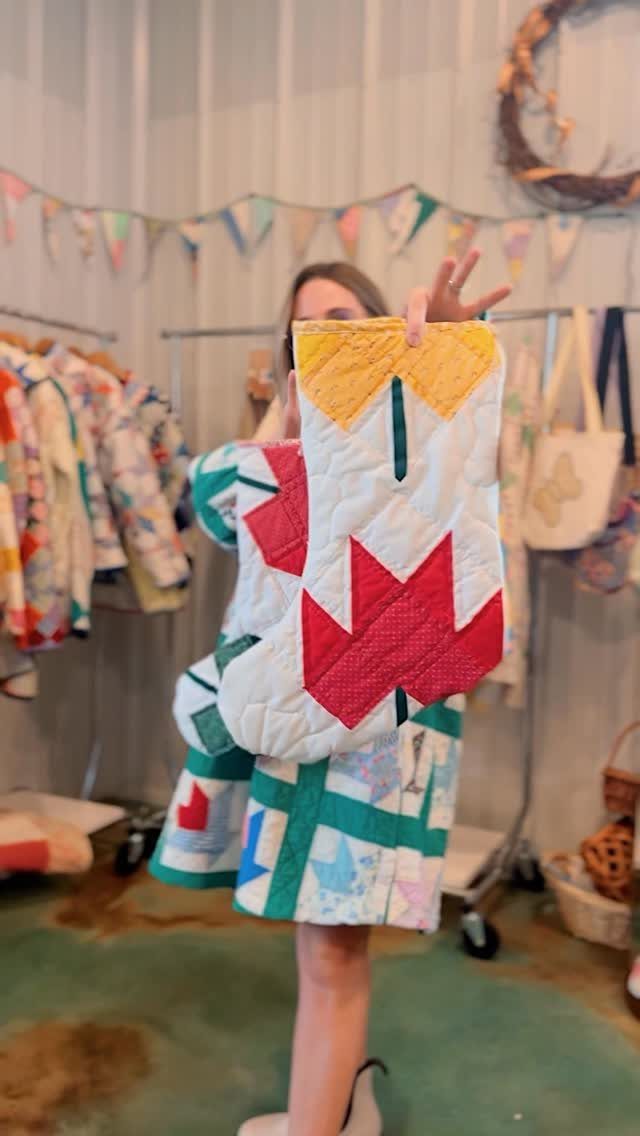 90s Christmas Tree Decor: 8 Ideas for Retro Holiday Charm 2 A person holding a large red, white, and yellow quilted Christmas stocking.