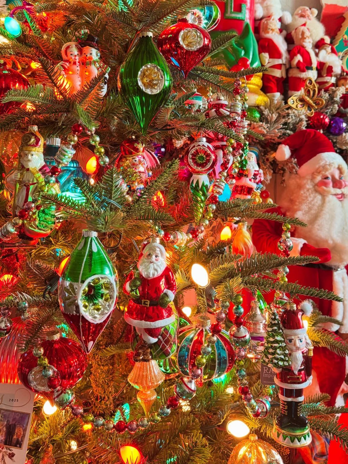 90s Christmas Tree Decor: 8 Ideas for Retro Holiday Charm 6 Vintage glass ornaments and Santa figurines decorating a brightly lit Christmas tree.