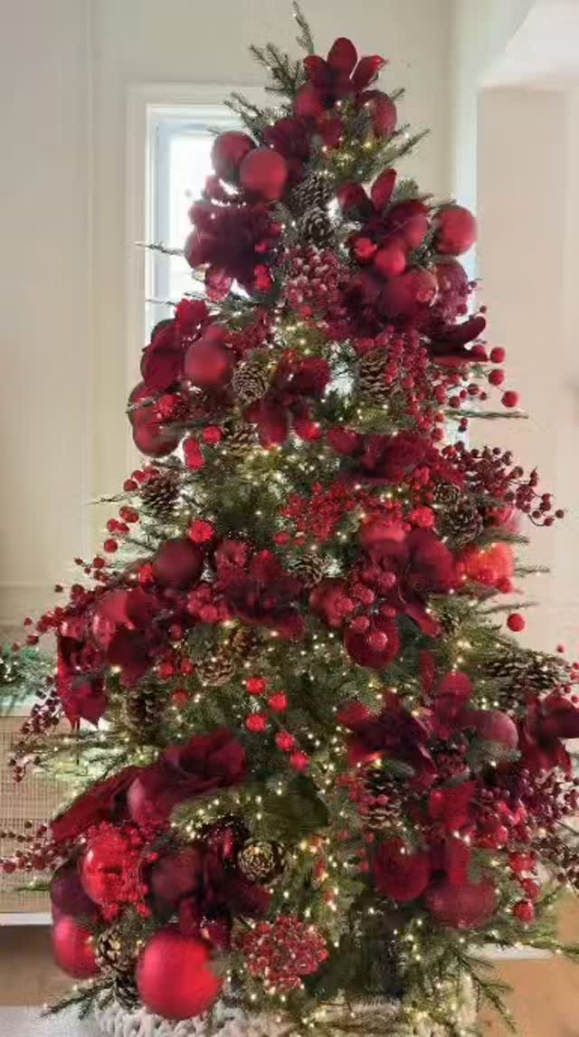 All Red Christmas Tree Decorations: 7 Ideas for Monochrome Style 7 A Christmas tree decorated with numerous red ornaments and warm glowing lights.