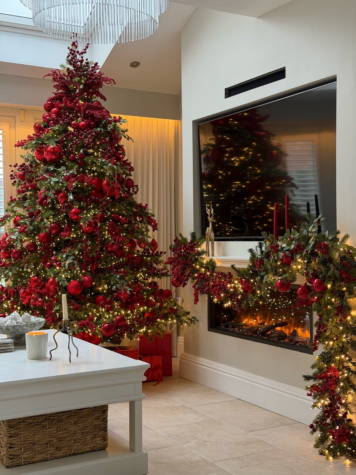 All Red Christmas Tree Decorations: 7 Ideas for Monochrome Style 2 A large Christmas tree decorated with red ornaments and warm lights in a living room.