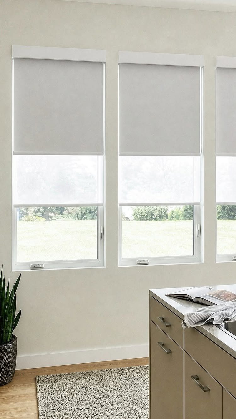 White roller shades installed on windows in a bright, modern kitchen setting.