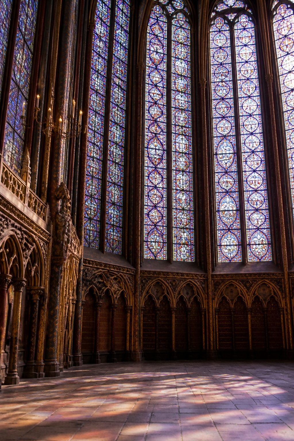 Beautiful Stained Glass Windows: 14 Sites That Changed Light Forever 1 Fifteen stained glass windows in a Gothic chapel filled with biblical scenes.