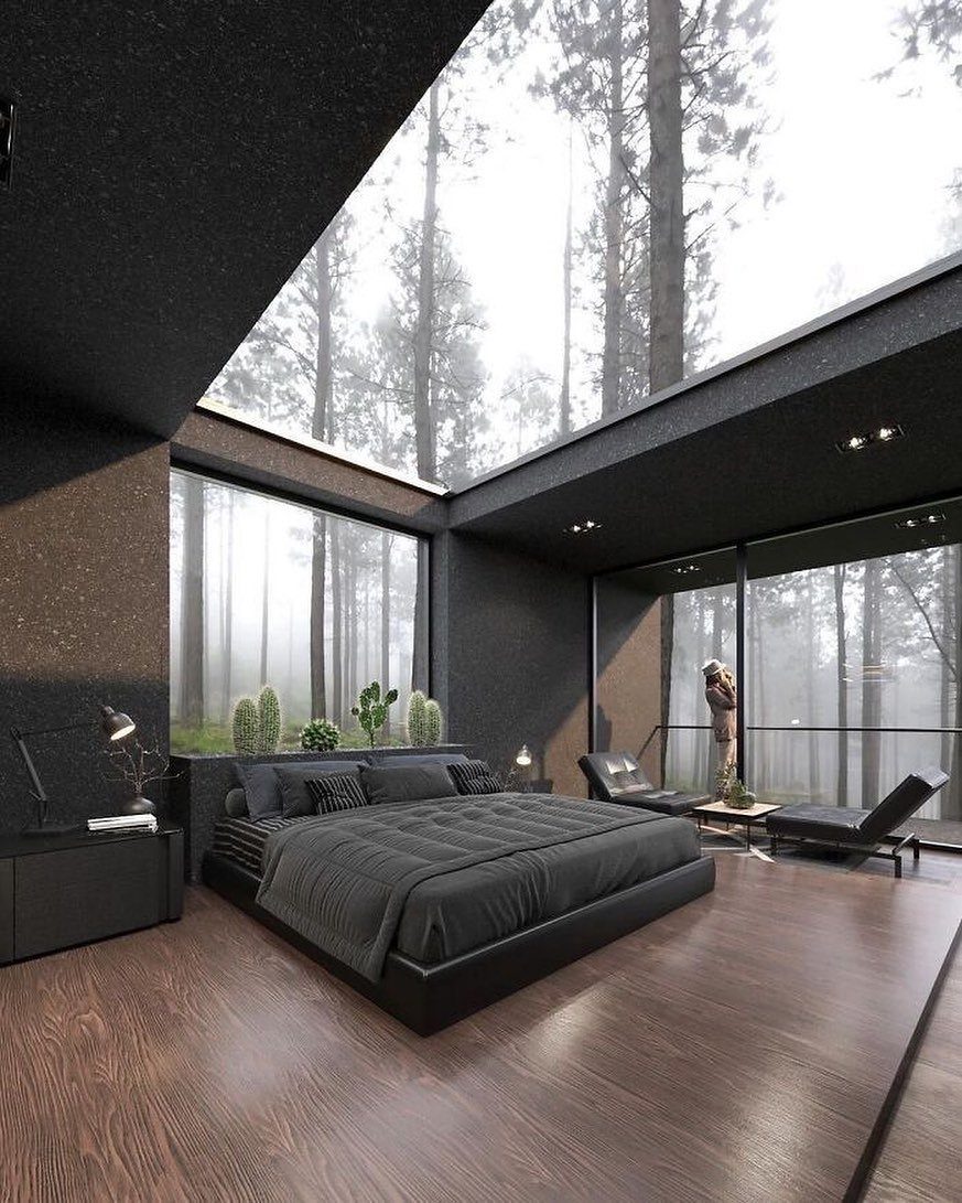 10 Bedroom Window Decor Ideas for Every Wall Height 1 Modern dark bedroom with large floor-to-ceiling windows overlooking a misty pine forest.