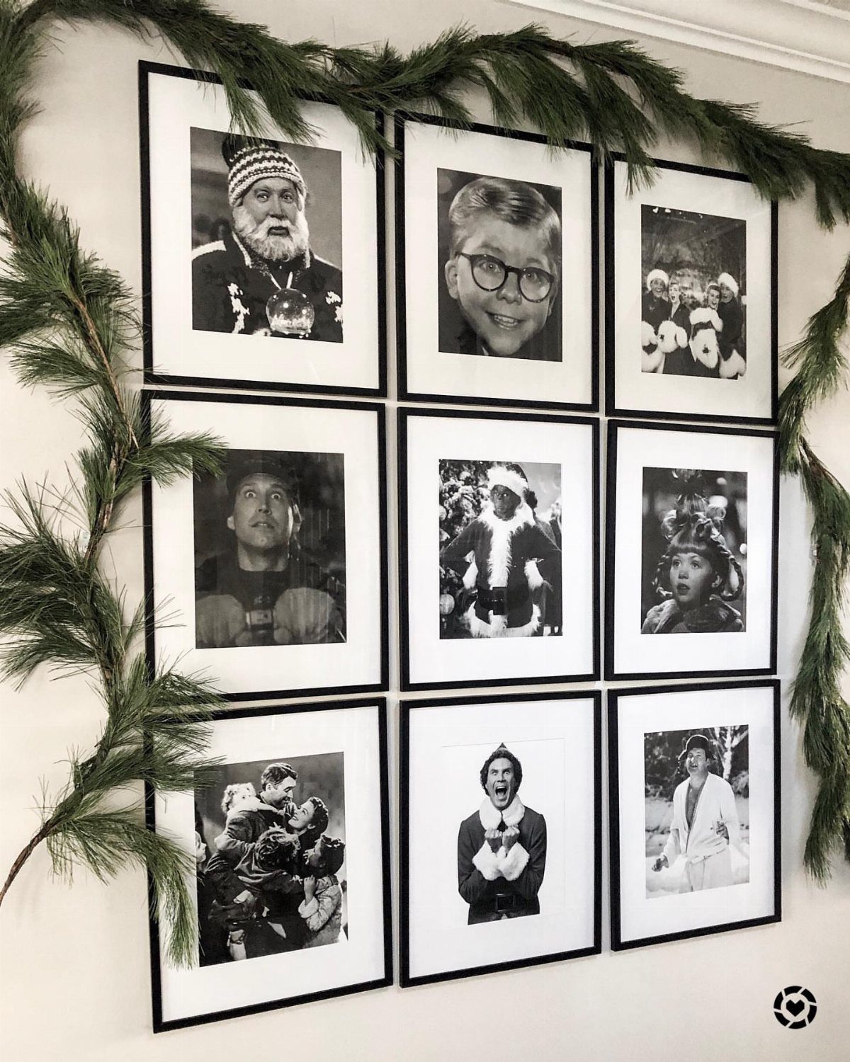 25 Christmas Decor Apartment Ideas That Maximize Space 7 Nine black and white framed photographs arranged in a grid on a white wall with greenery.