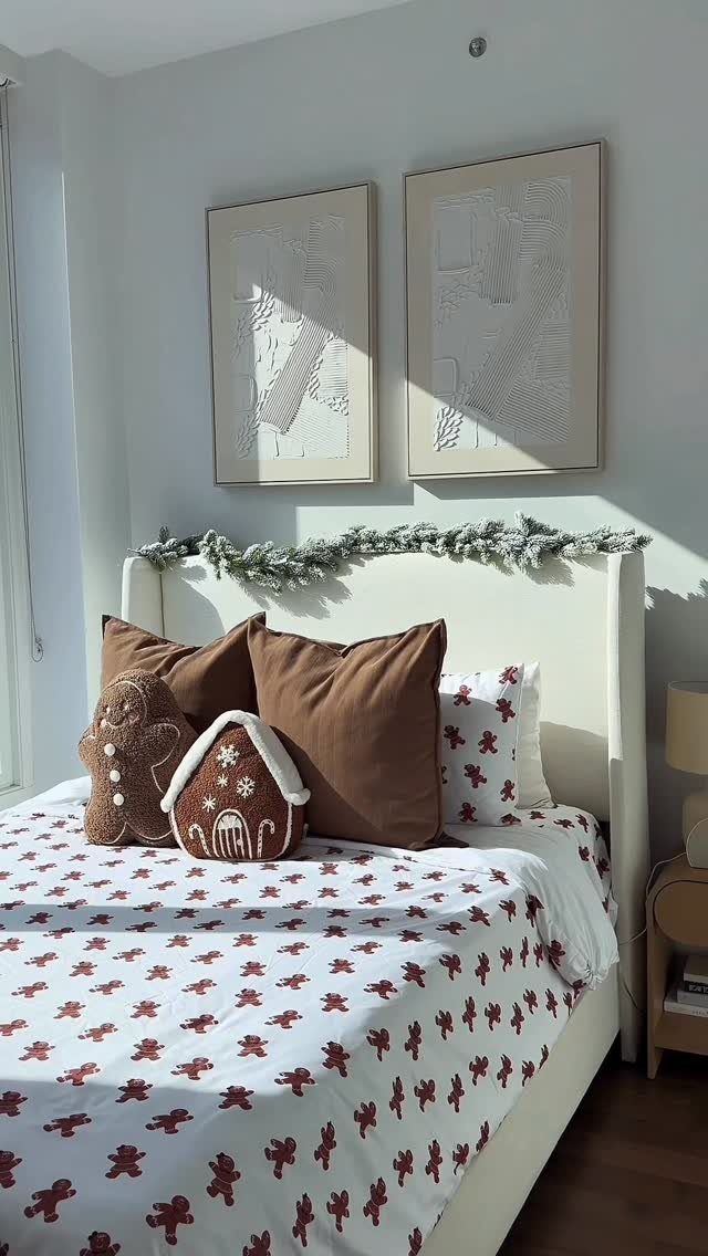 25 Christmas Decor Apartment Ideas That Maximize Space 21 A bed decorated with gingerbread man patterned bedding and festive gingerbread shaped pillows and garland.