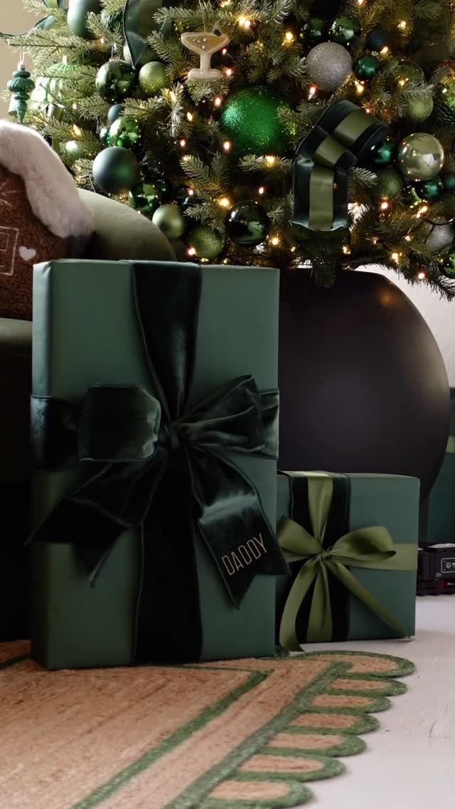 11 Christmas Home Decorating Ideas for 2026: Garlands to Lanterns 5 Green wrapped gift boxes with large bows sitting in front of a decorated Christmas tree.