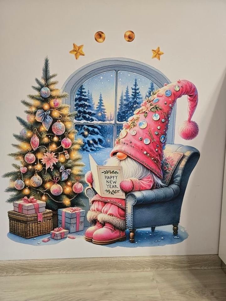 11 Christmas Home Decorating Ideas for 2026: Garlands to Lanterns 6 A large Christmas wall decal showing a pink gnome reading by a decorated tree.