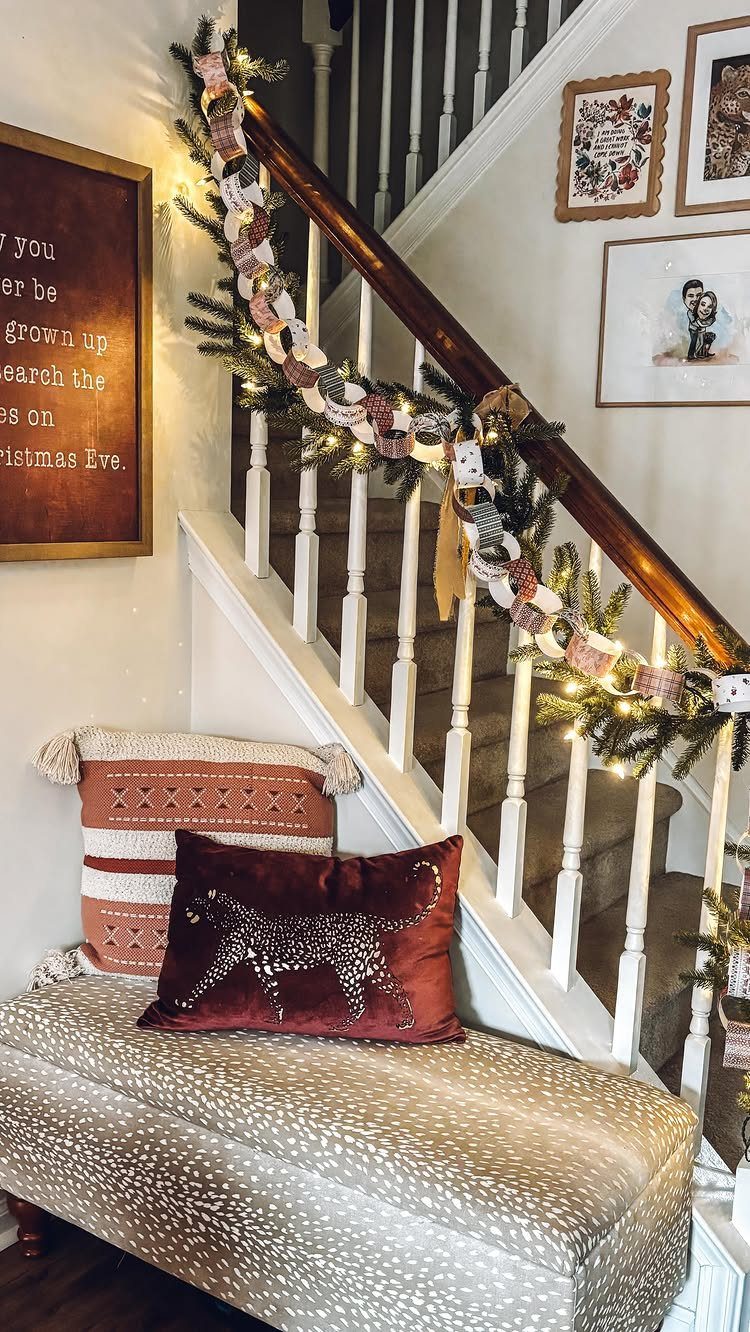 11 Christmas Home Decorating Ideas for 2026: Garlands to Lanterns 1 A staircase banister adorned with evergreen garland, fairy lights, and a patterned paper chain garland.