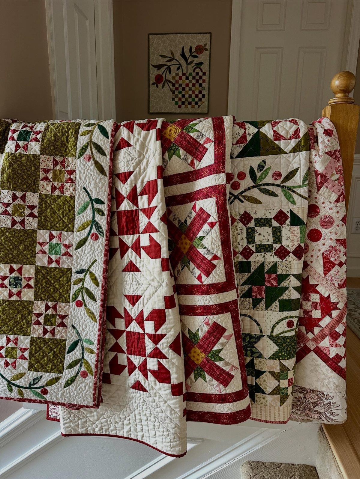 20 Christmas Rustic Decor Ideas for a Warm Holiday Home 15 Several red, green, and white patterned Christmas quilts draped over a wooden bed frame.