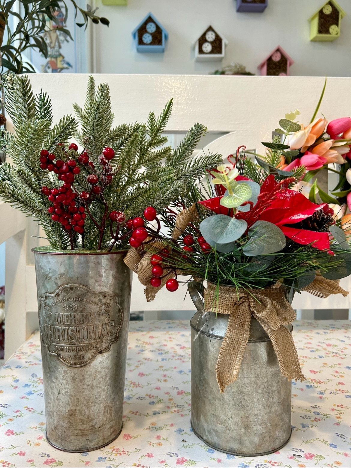20 Christmas Rustic Decor Ideas for a Warm Holiday Home 14 Two galvanized metal buckets filled with festive evergreen branches and red berries on a table.