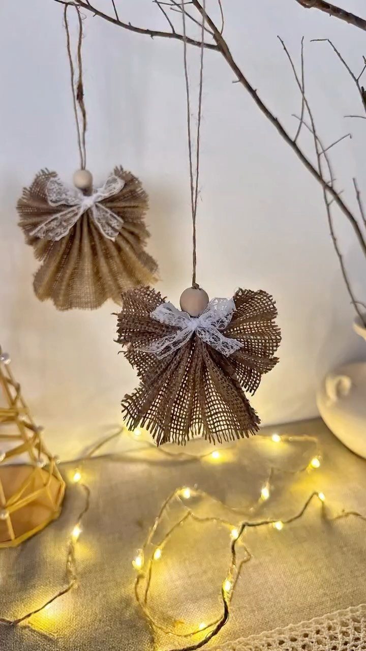 20 Christmas Rustic Decor Ideas for a Warm Holiday Home 12 Two burlap and lace angel ornaments hanging from thin tree branches above glowing fairy lights.