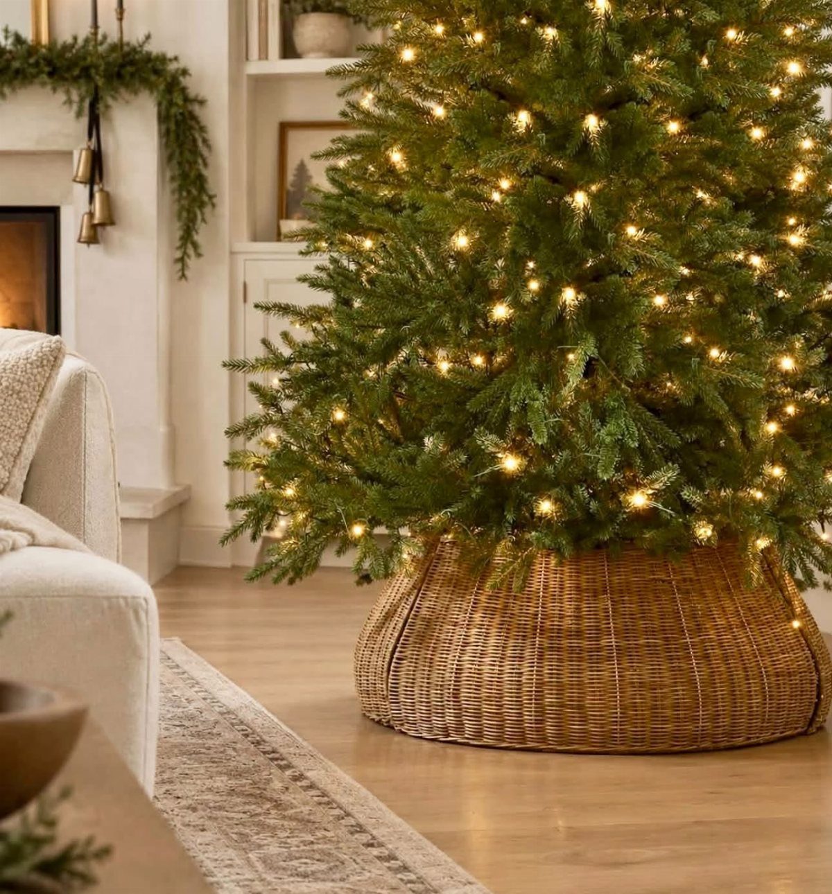 20 Christmas Rustic Decor Ideas for a Warm Holiday Home 13 A lit Christmas tree sits in a large woven wicker basket tree skirt in a living room.