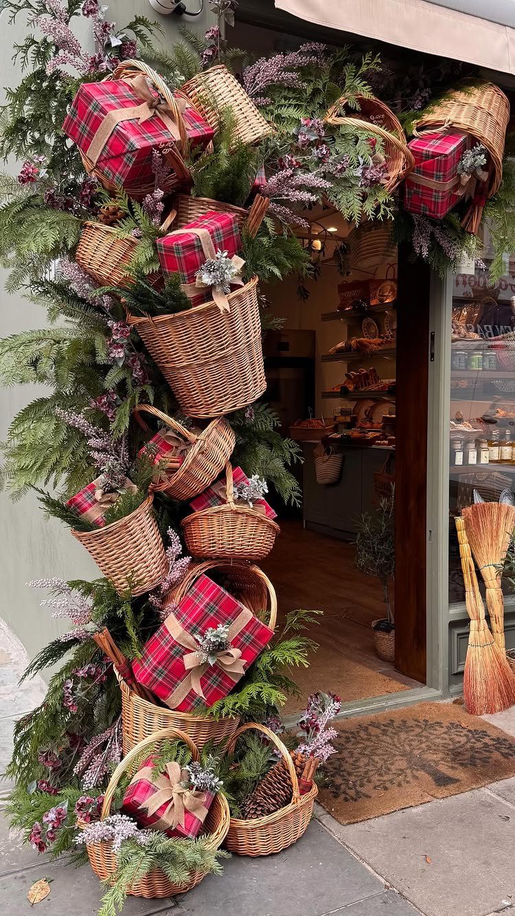 20 Christmas Rustic Decor Ideas for a Warm Holiday Home 2 Wicker baskets filled with greenery and plaid gifts decorating a shop entrance.