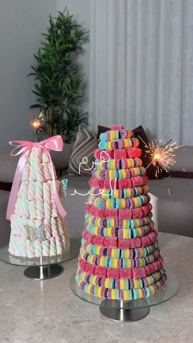 DIY Candyland Decorations: 10 Creative Party Ideas 7 Two conical candy towers, one pastel marshmallow and one colorful ring candy, on glass stands.