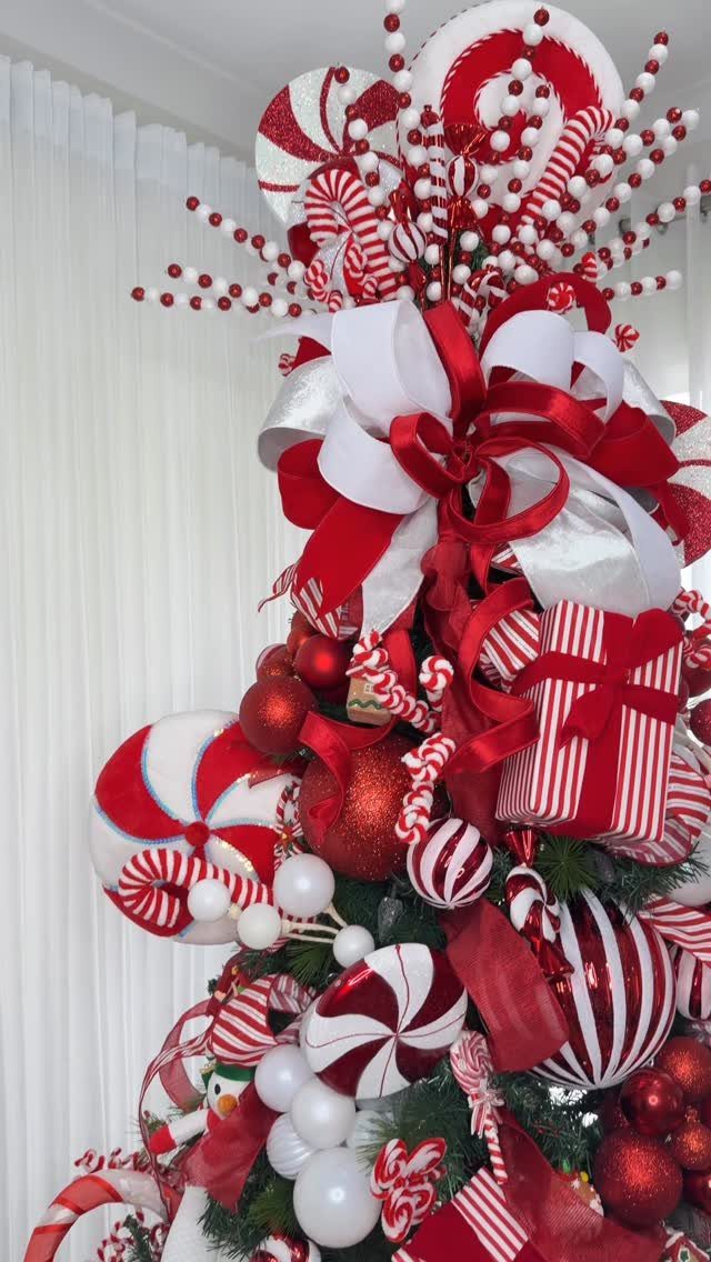 Red and white candy themed Christmas tree decorations including peppermint ornaments and striped candy canes.