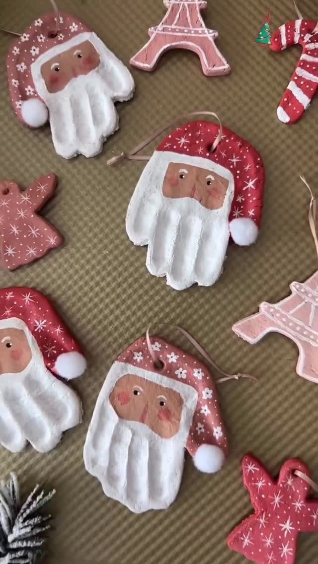Handmade salt dough ornaments shaped like Santa Claus and the Eiffel Tower on a brown surface.