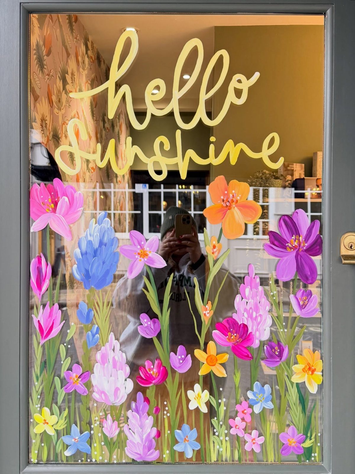 Front Window Design Ideas: 11 Looks Worth Stealing for 2026 5 Painted colorful flowers and yellow sunshine text on a glass window pane.