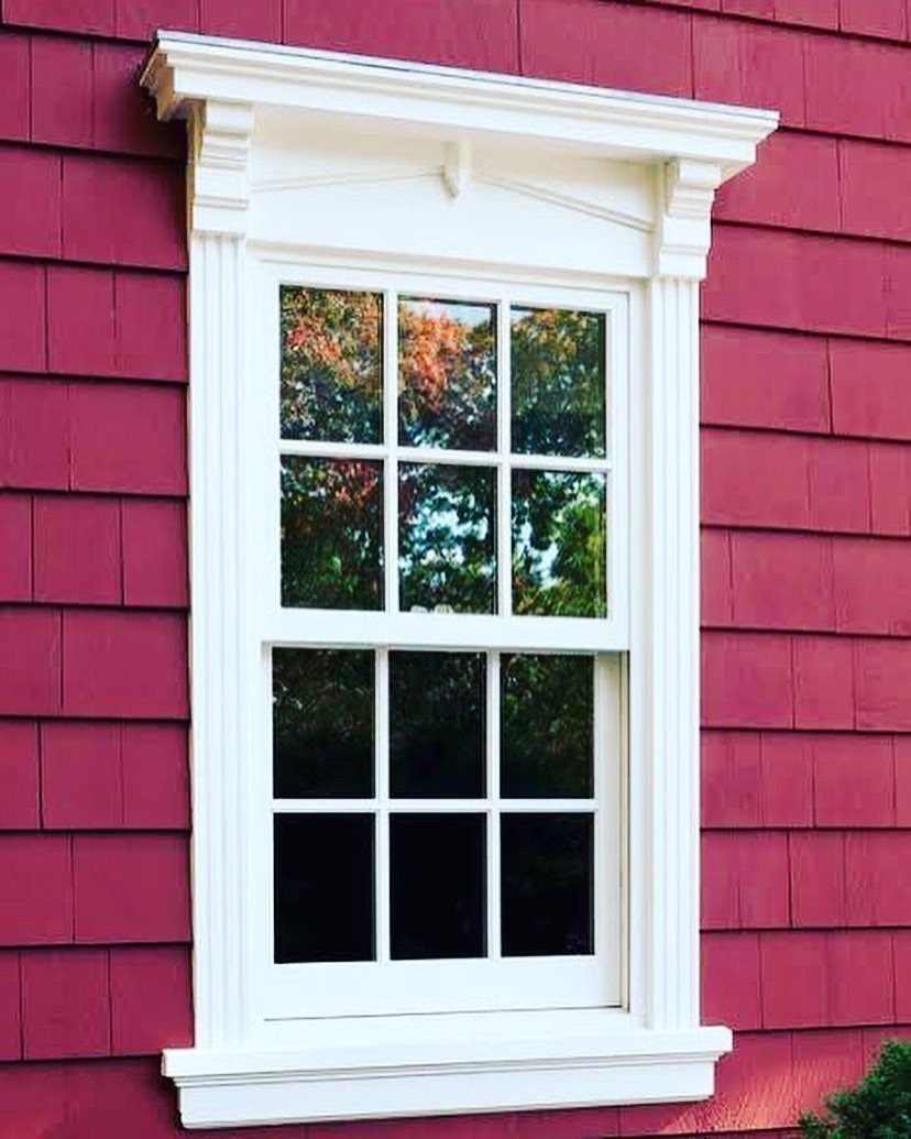 Front Window Design Ideas: 11 Looks Worth Stealing for 2026 8 A white double-hung window with grids set into a red shingle wall.