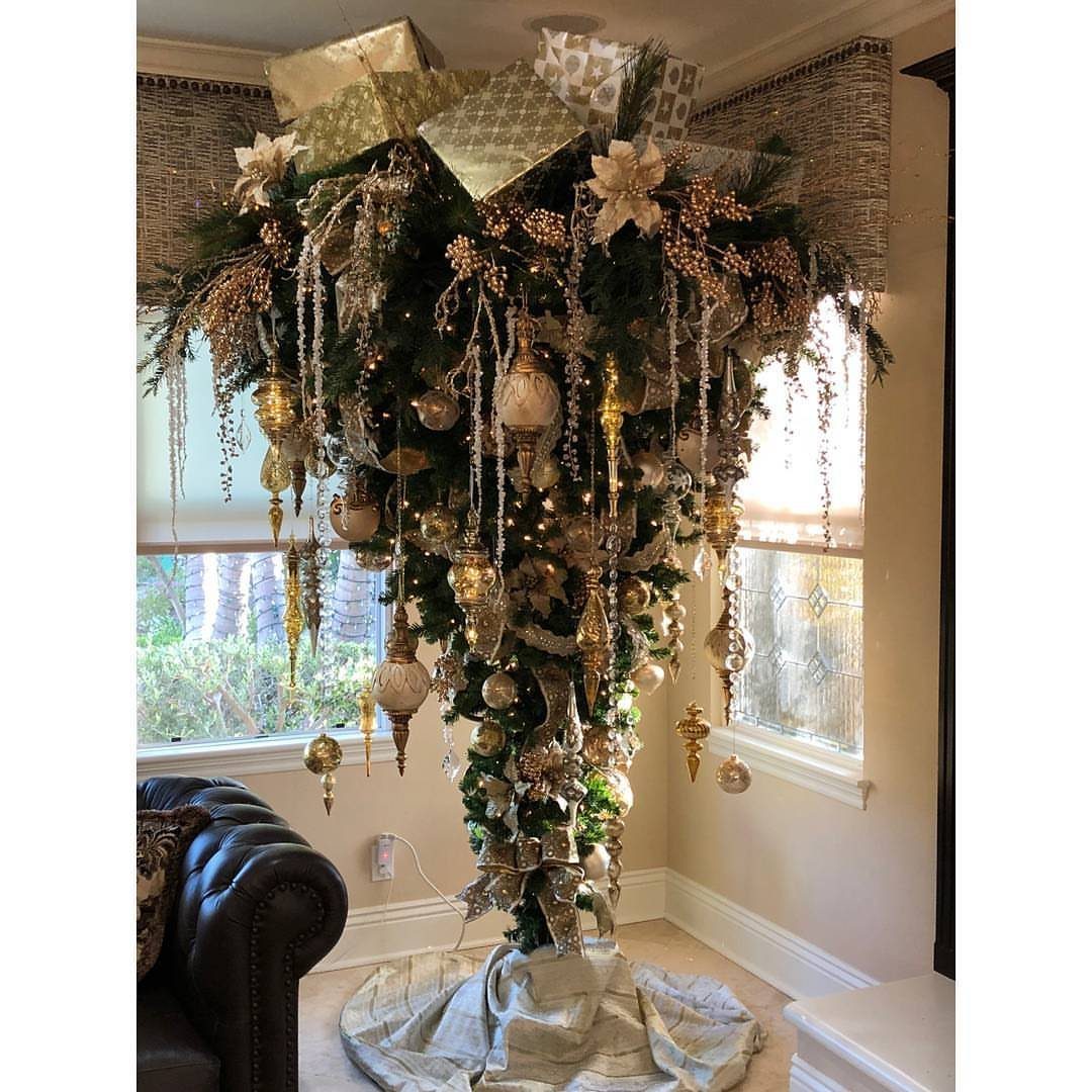 Hanging Christmas Tree: 6 Ideas for Small Spaces 5 An upside-down Christmas tree decorated with gold ornaments and gifts hanging in a bright living room.