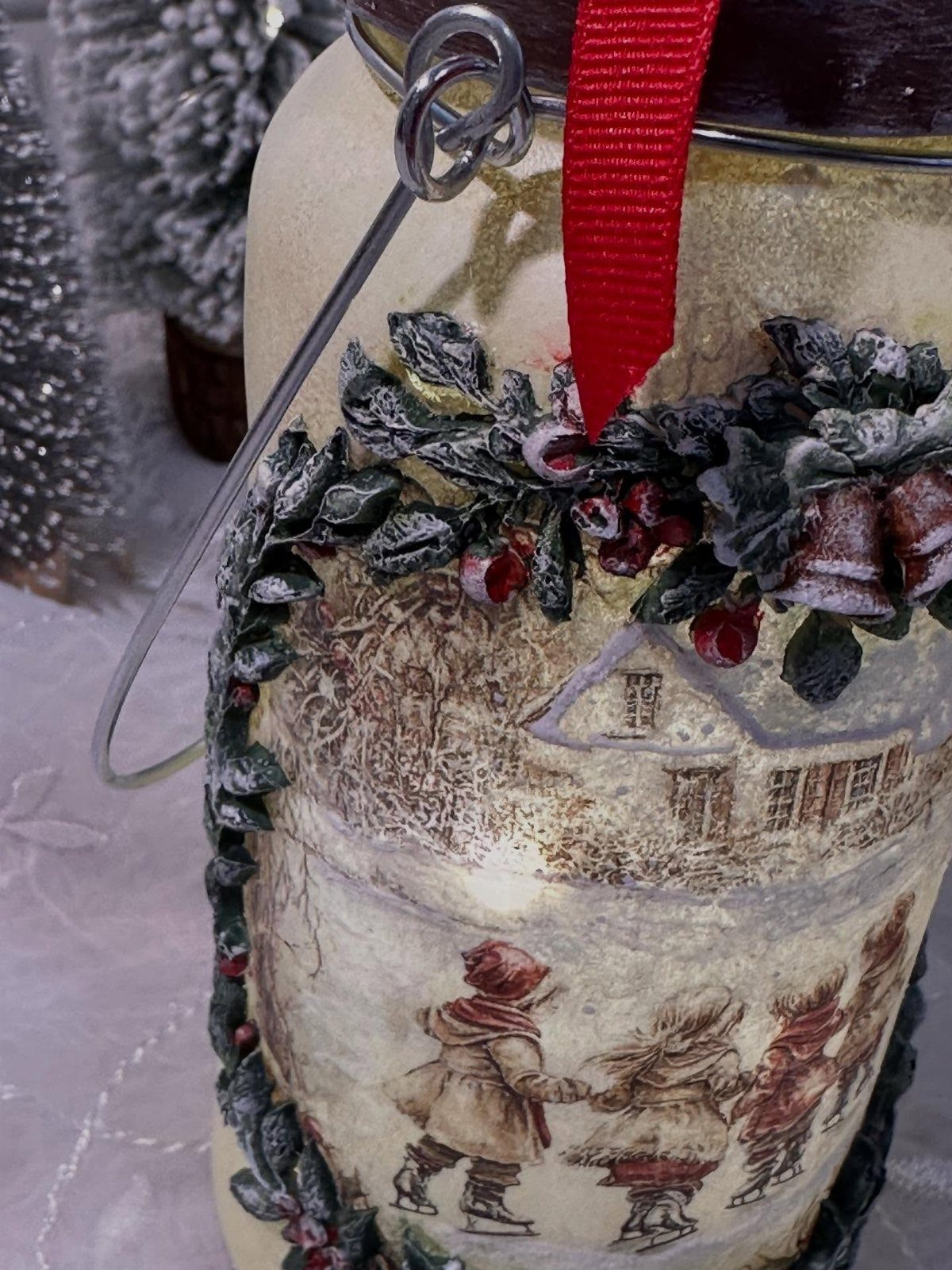 Homemade Christmas Decorations: 17 Easy Projects for 2026 17 A decorated glass jar with vintage illustrations, festive berry garlands, and a red ribbon.