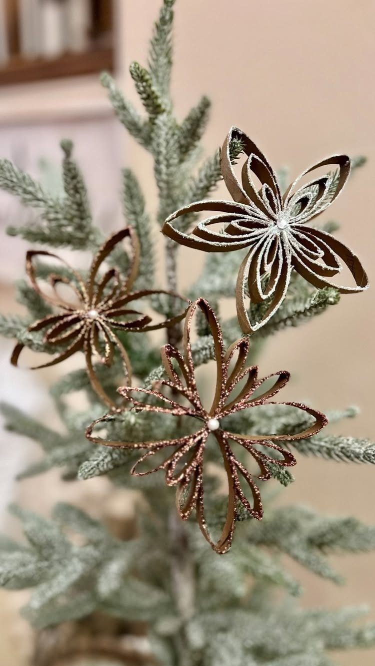 Homemade Christmas Decorations: 17 Easy Projects for 2026 11 Glittery gold paper ornaments hanging on the branches of a frosted evergreen Christmas tree.