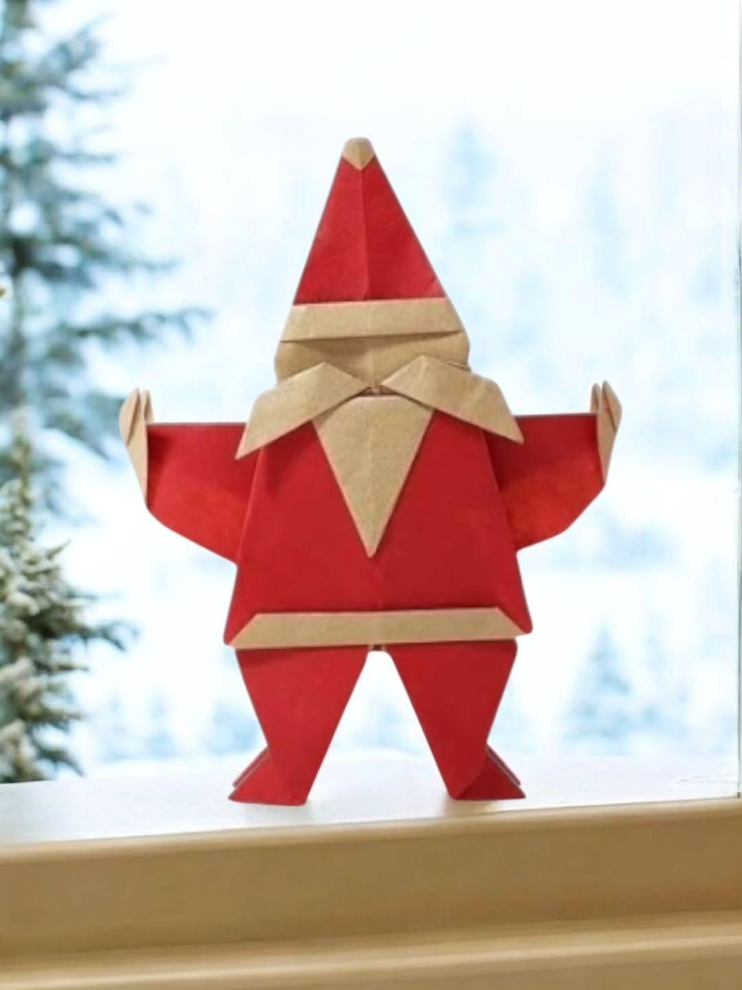 Homemade Christmas Decorations: 17 Easy Projects for 2026 3 An origami Santa Claus figure made of red and tan paper on a white windowsill.