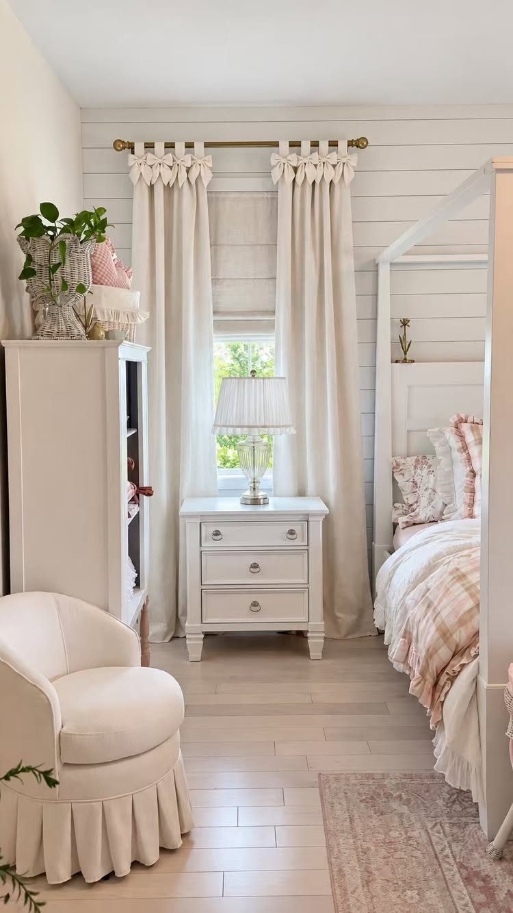 13 House Curtains Ideas for Every Style 2 Cream tie top curtains hanging from a gold rod in a bright, white shiplap bedroom.