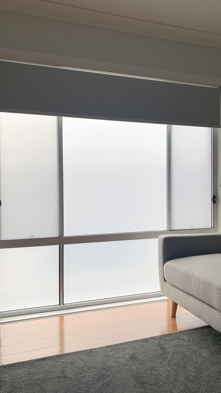 Temporary Window Privacy Ideas: 4 Ways to Block the View 2 Frosted window panes providing privacy in a modern living room with grey furniture and wooden floors.