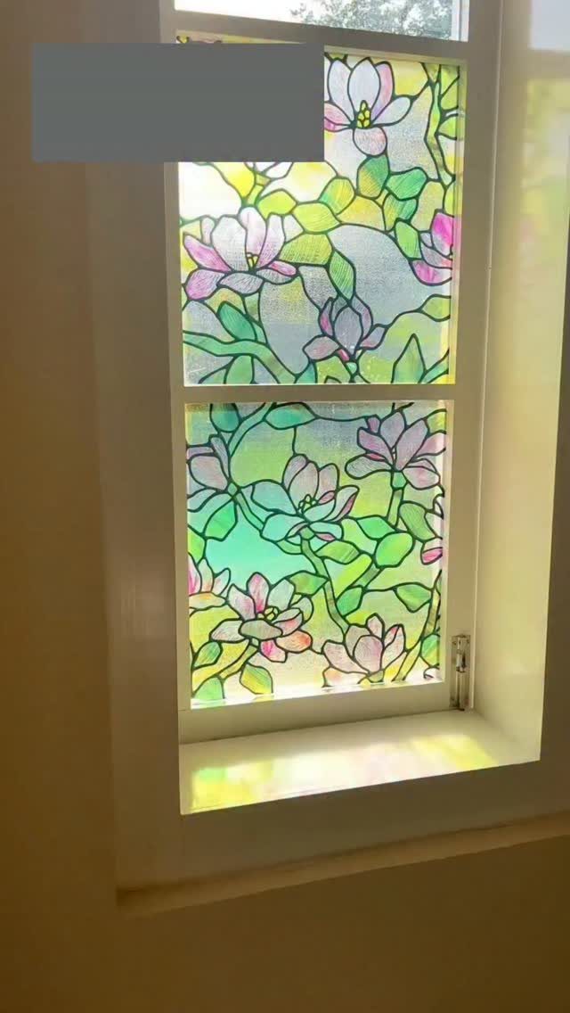 Temporary Window Privacy Ideas: 4 Ways to Block the View 1 Floral patterned static cling film applied to a window pane with sunlight shining through.