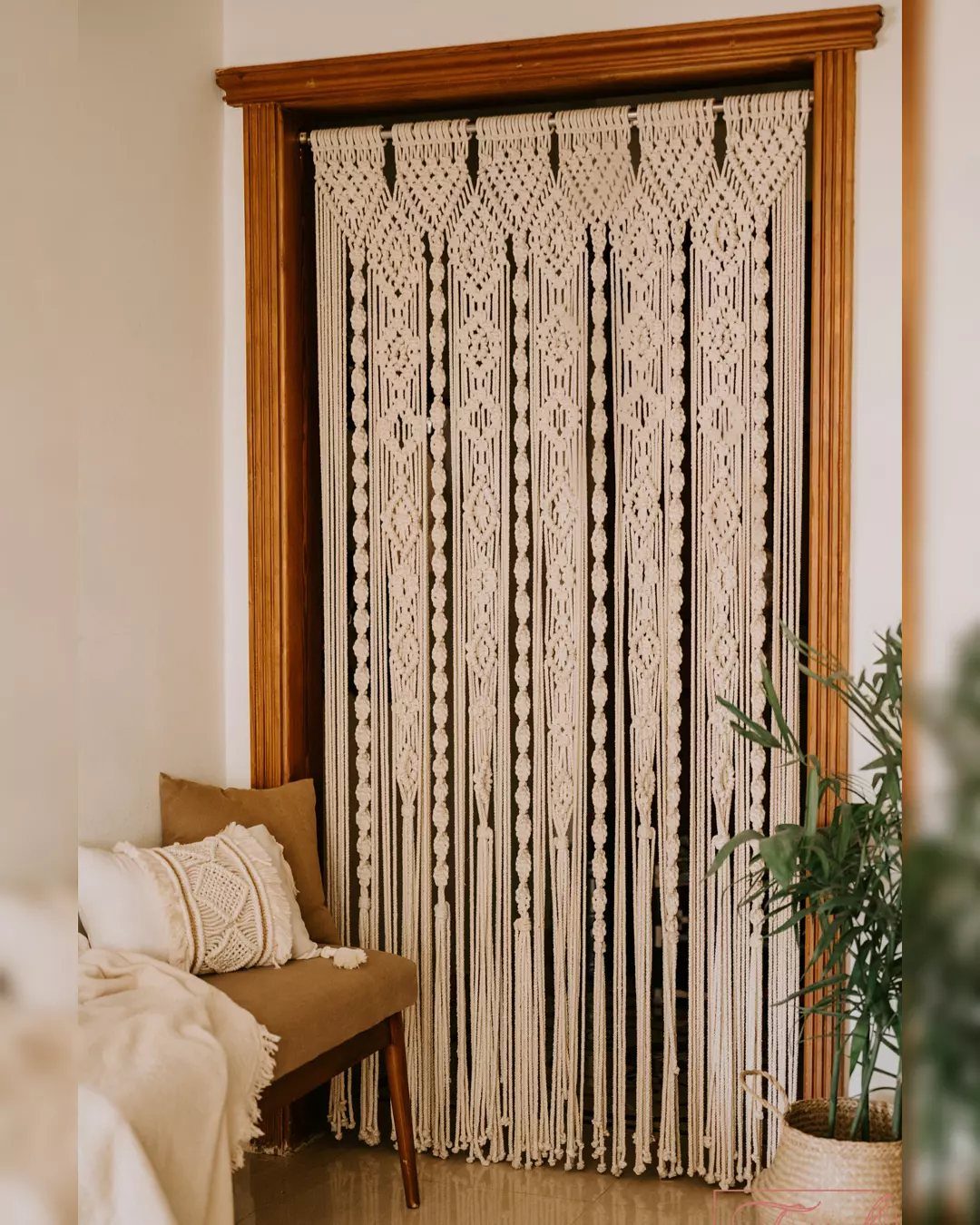 22 Unique Bedroom Curtains for Layered, Canopy and Lighted Styles 4 Macramé curtain panels with intricate knot patterns hanging in a wooden window frame.