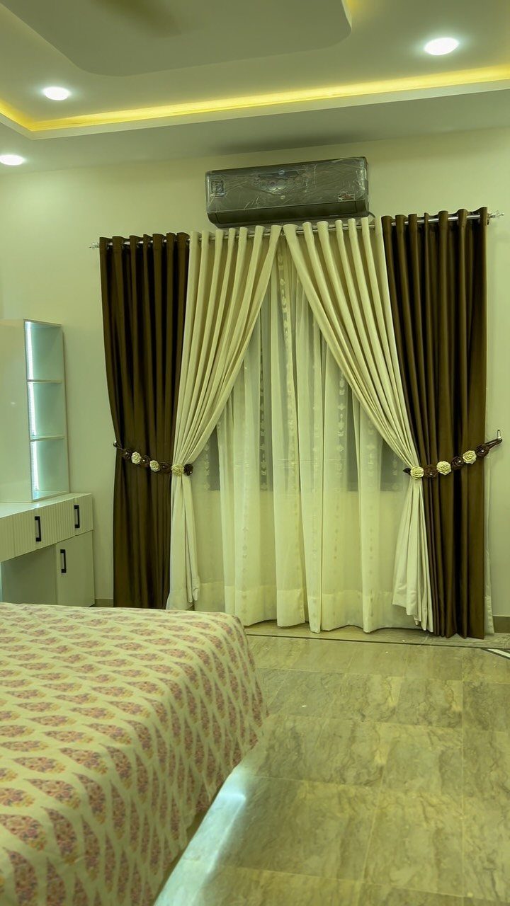 22 Unique Bedroom Curtains for Layered, Canopy and Lighted Styles 1 Brown and cream layered curtains hanging over a window in a bedroom setting.