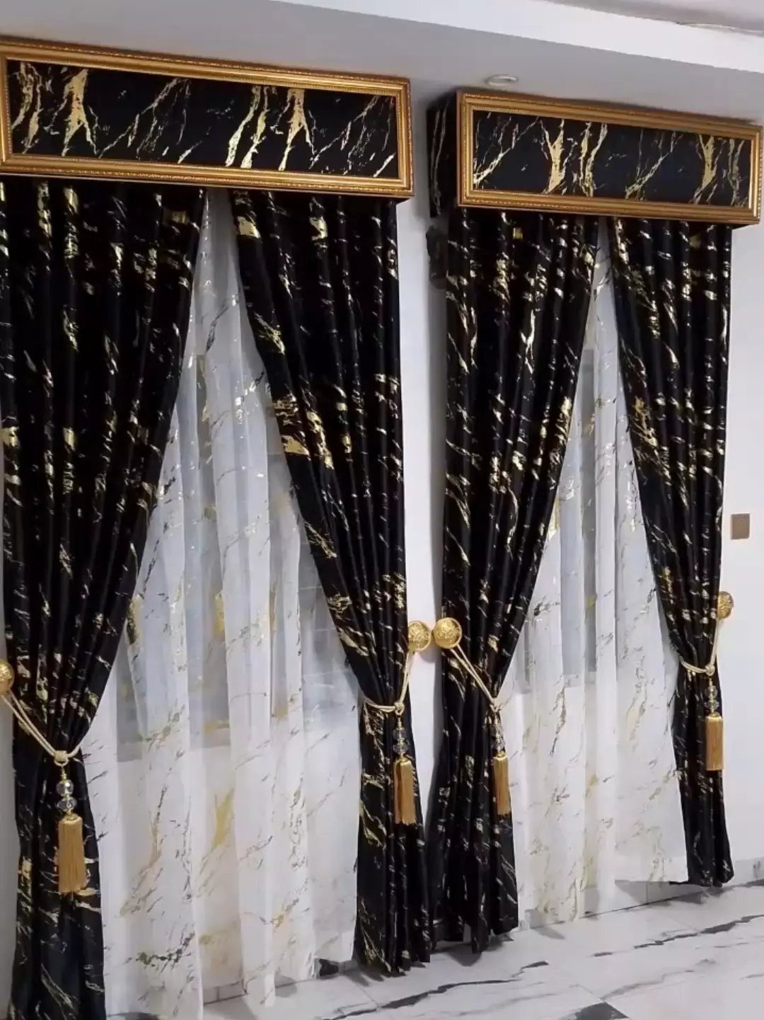 22 Unique Bedroom Curtains for Layered, Canopy and Lighted Styles 13 Black and white marble print curtains with gold veins hanging over a window.