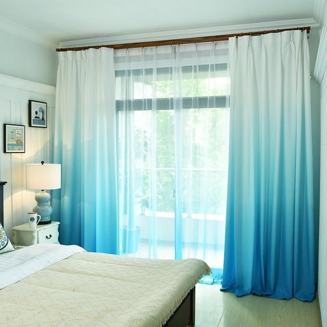 22 Unique Bedroom Curtains for Layered, Canopy and Lighted Styles 18 Blue and white ombre curtains hanging over a large window in a bright bedroom.