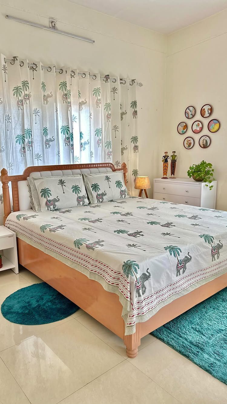 22 Unique Bedroom Curtains for Layered, Canopy and Lighted Styles 11 Tropical print bedding and matching sheer curtains in a cream-colored bedroom setting.