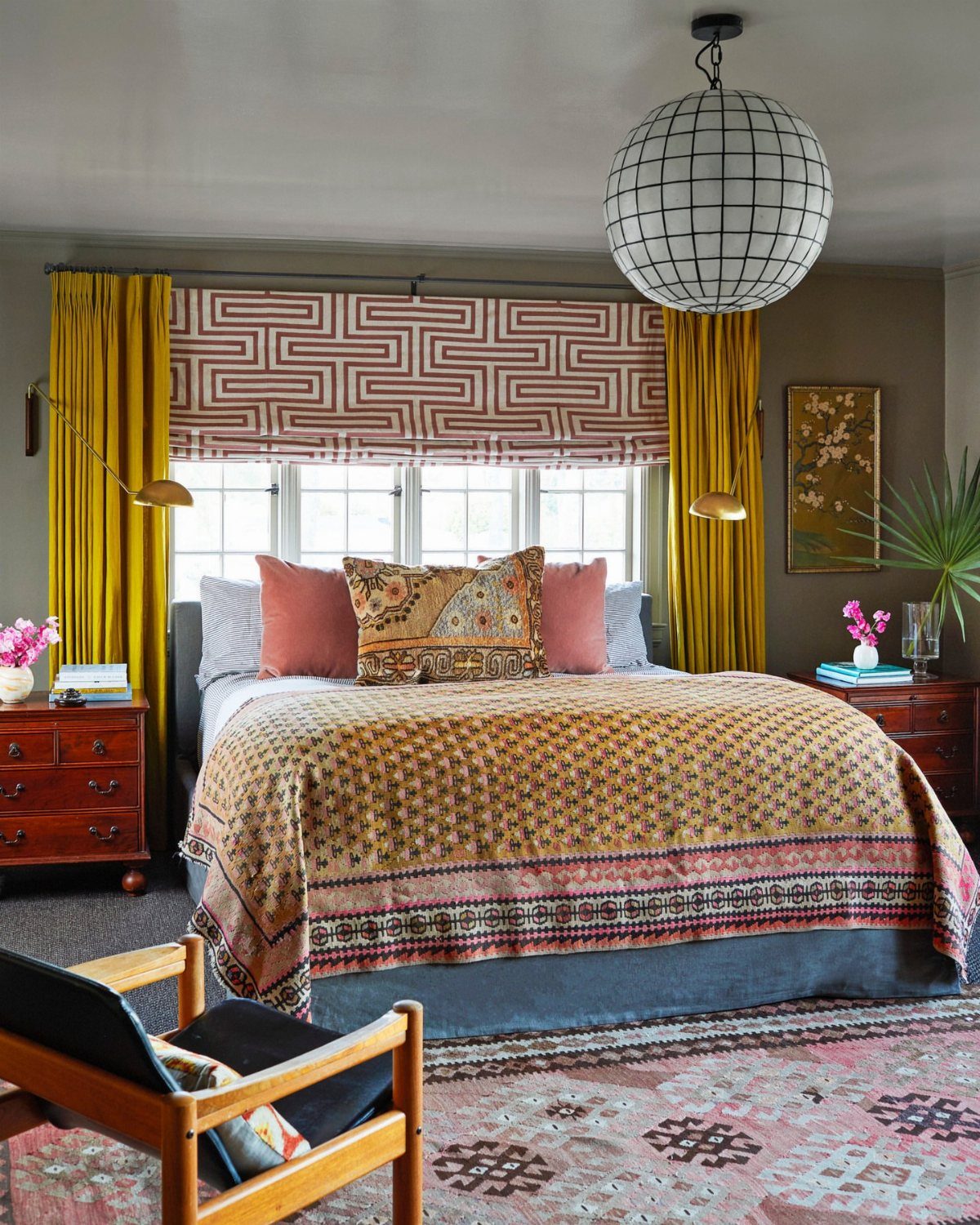22 Unique Bedroom Curtains for Layered, Canopy and Lighted Styles 3 Mustard yellow curtains frame a window with a patterned roman shade above a decorated bed.