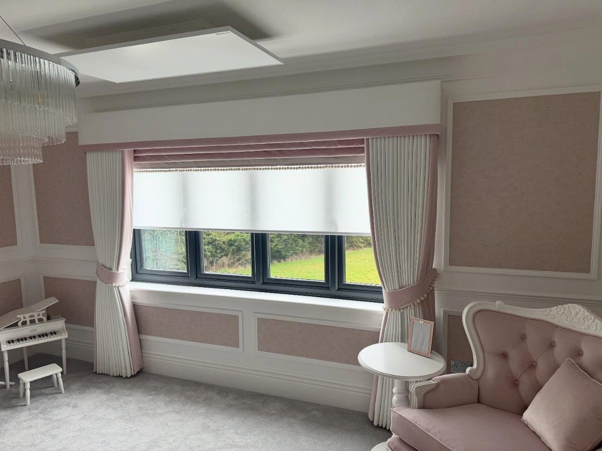 11 Ways to Style Curtains for Every Room in 2026 11 White and pink curtains tied back on either side of a large window with a roller blind.