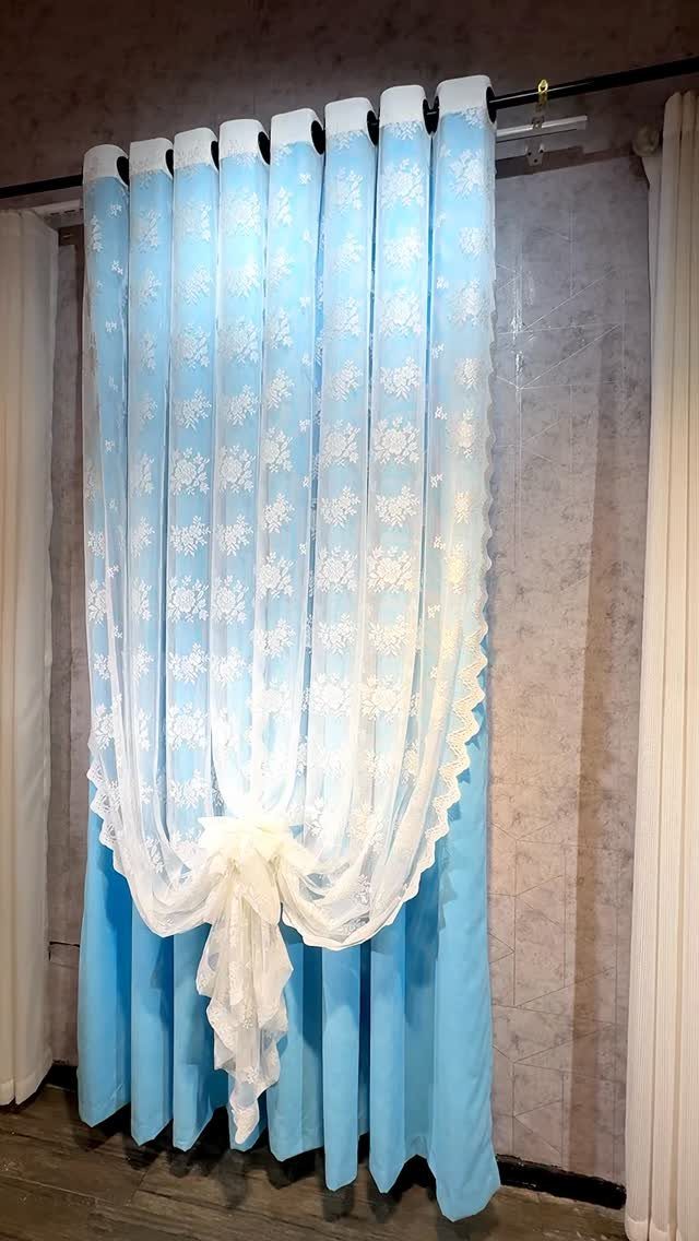 11 Ways to Style Curtains for Every Room in 2026 4 Light blue curtains with a white lace sheer panel tied in a central knot.