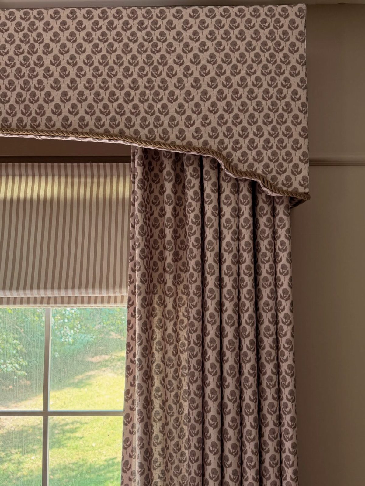 Window Cornice DIY: 5 Ways With Fabric, Wood, and Molding 1 Patterned fabric upholstered cornice with a scalloped edge hanging above matching curtains and a striped shade.