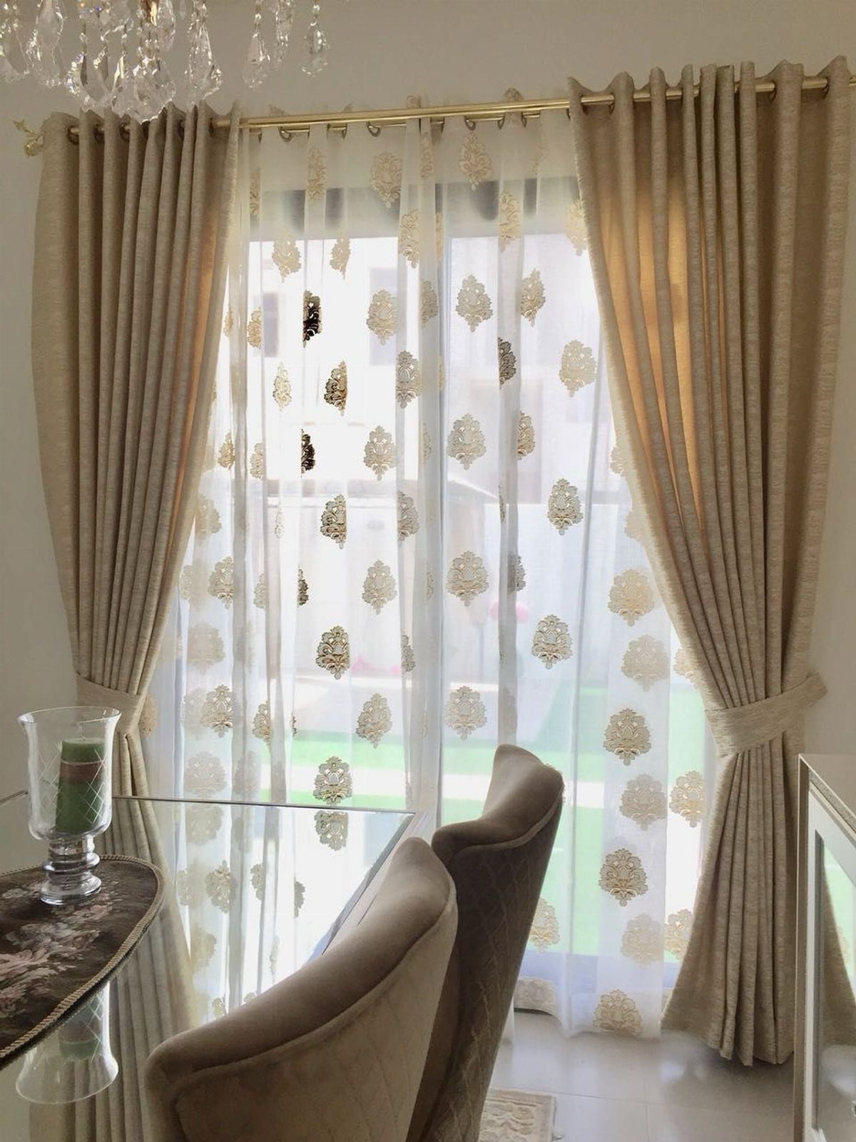 10 Window Dressing Ideas for Shutters, Shades and Blinds 8 Sheer white curtains with gold floral patterns framed by heavy cream drapery panels.