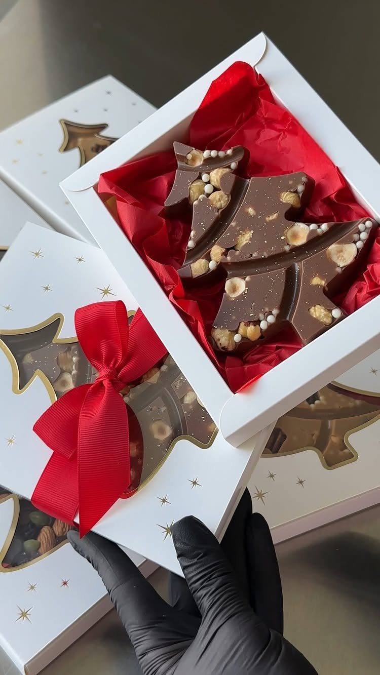 32 Xmas Gifts to Make: Easy Ideas for Handmade Holiday Presents 30 Chocolate tree-shaped treats with nuts in white gift boxes with red tissue paper.