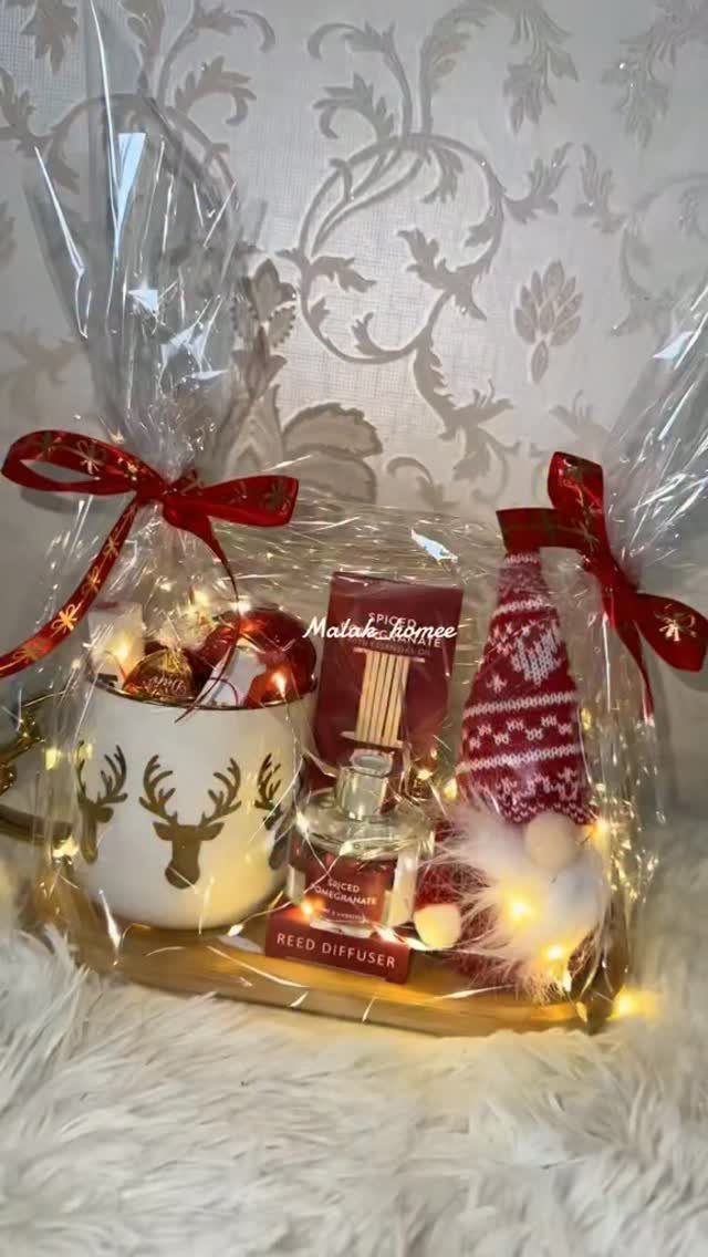 32 Xmas Gifts to Make: Easy Ideas for Handmade Holiday Presents 32 A Christmas gift basket containing a reindeer mug, reed diffuser, and gnome decorated with fairy lights.