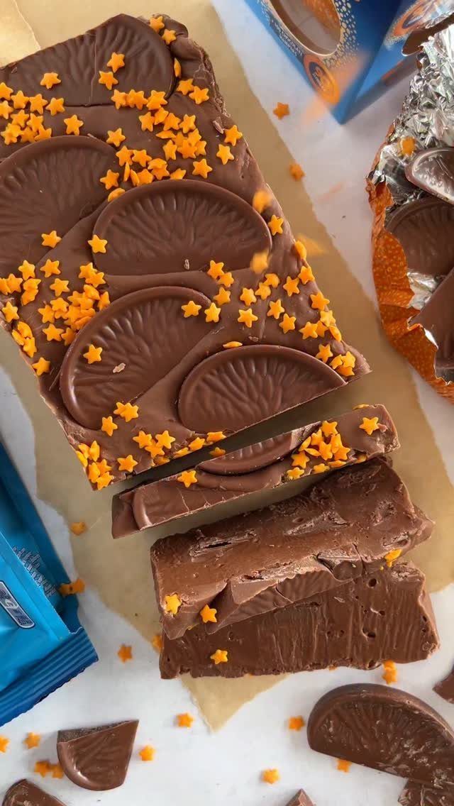 32 Xmas Gifts to Make: Easy Ideas for Handmade Holiday Presents 20 Chocolate fudge topped with orange star sprinkles and chocolate citrus slices on parchment paper.