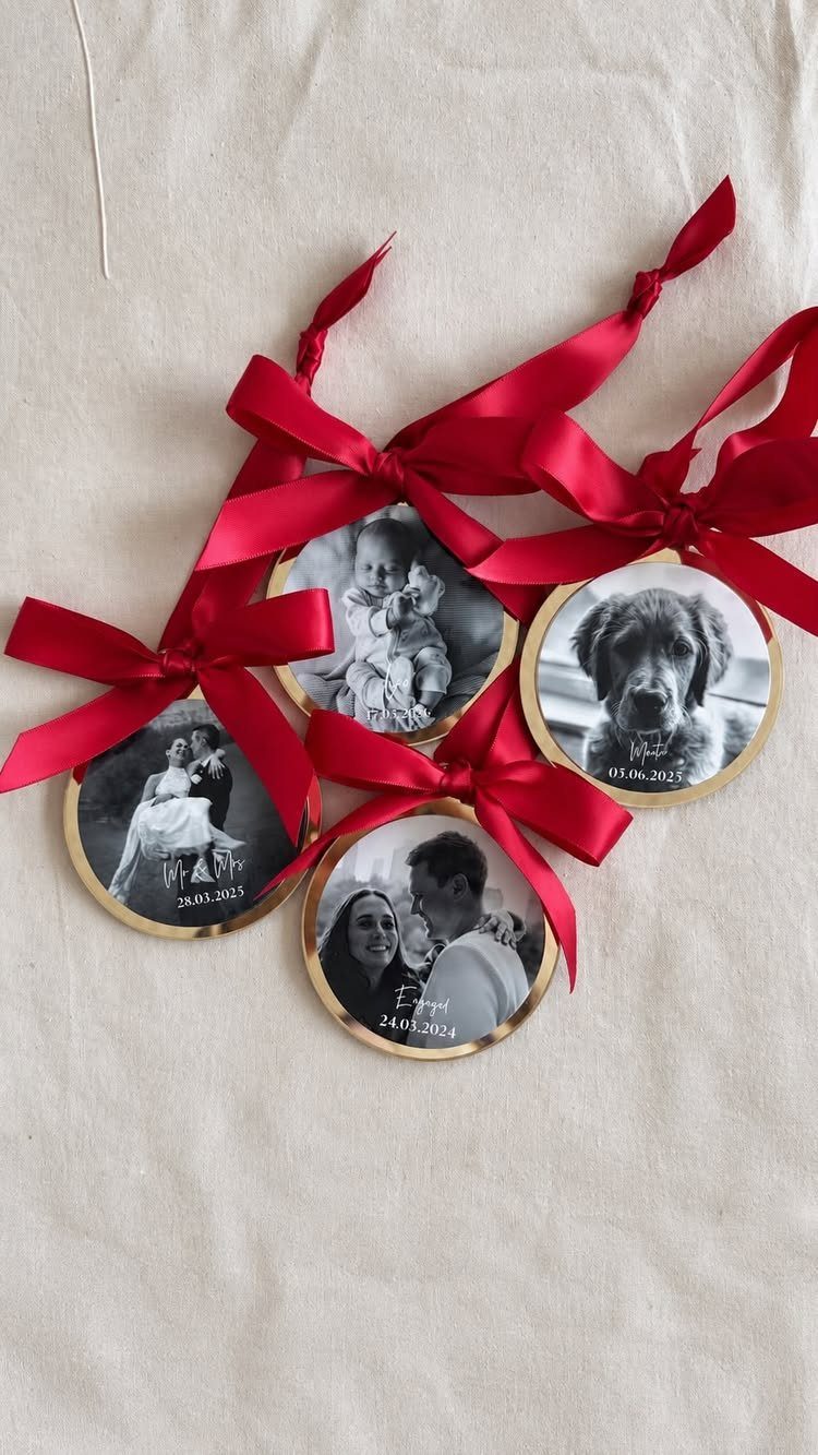32 Xmas Gifts to Make: Easy Ideas for Handmade Holiday Presents 5 Four gold-rimmed photo ornaments with red ribbons resting on a beige fabric background.