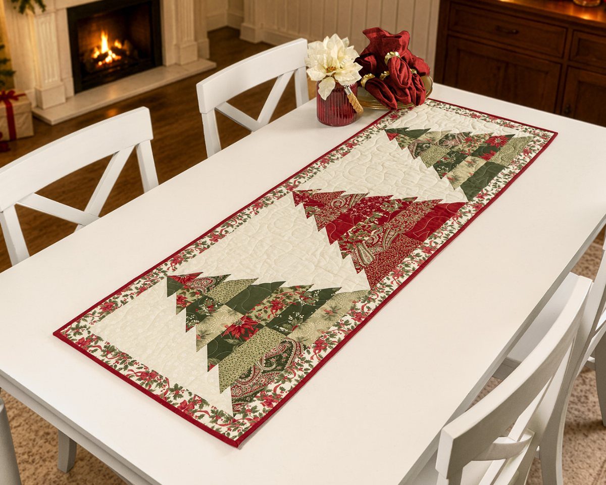 32 Xmas Gifts to Make: Easy Ideas for Handmade Holiday Presents 14 A quilted Christmas table runner with tree patterns on a white dining table.